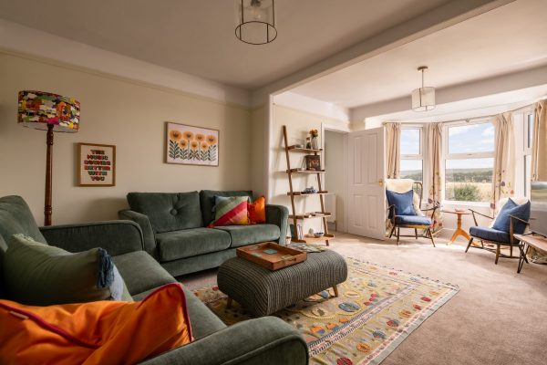 Delightful sitting room with comfy sofas and seating by the windows for fantastic views.