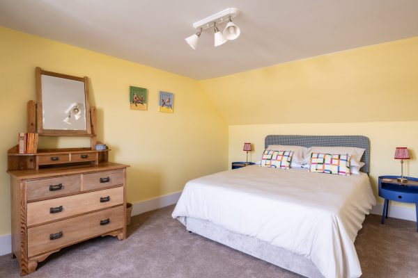 Modern decoration meets traditional farmhouse in this comfortable double bedroom